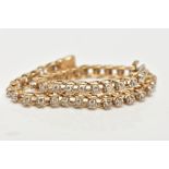 A 9CT GOLD DIAMOND LINE BRACELET, each brilliant cut diamond within a four claw setting, to the push