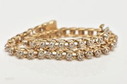 A 9CT GOLD DIAMOND LINE BRACELET, each brilliant cut diamond within a four claw setting, to the push