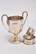 A MINIATURE SILVER TROPHY CUP AND TWO SILVER NAPKIN RING, plain polished body raised on a circular