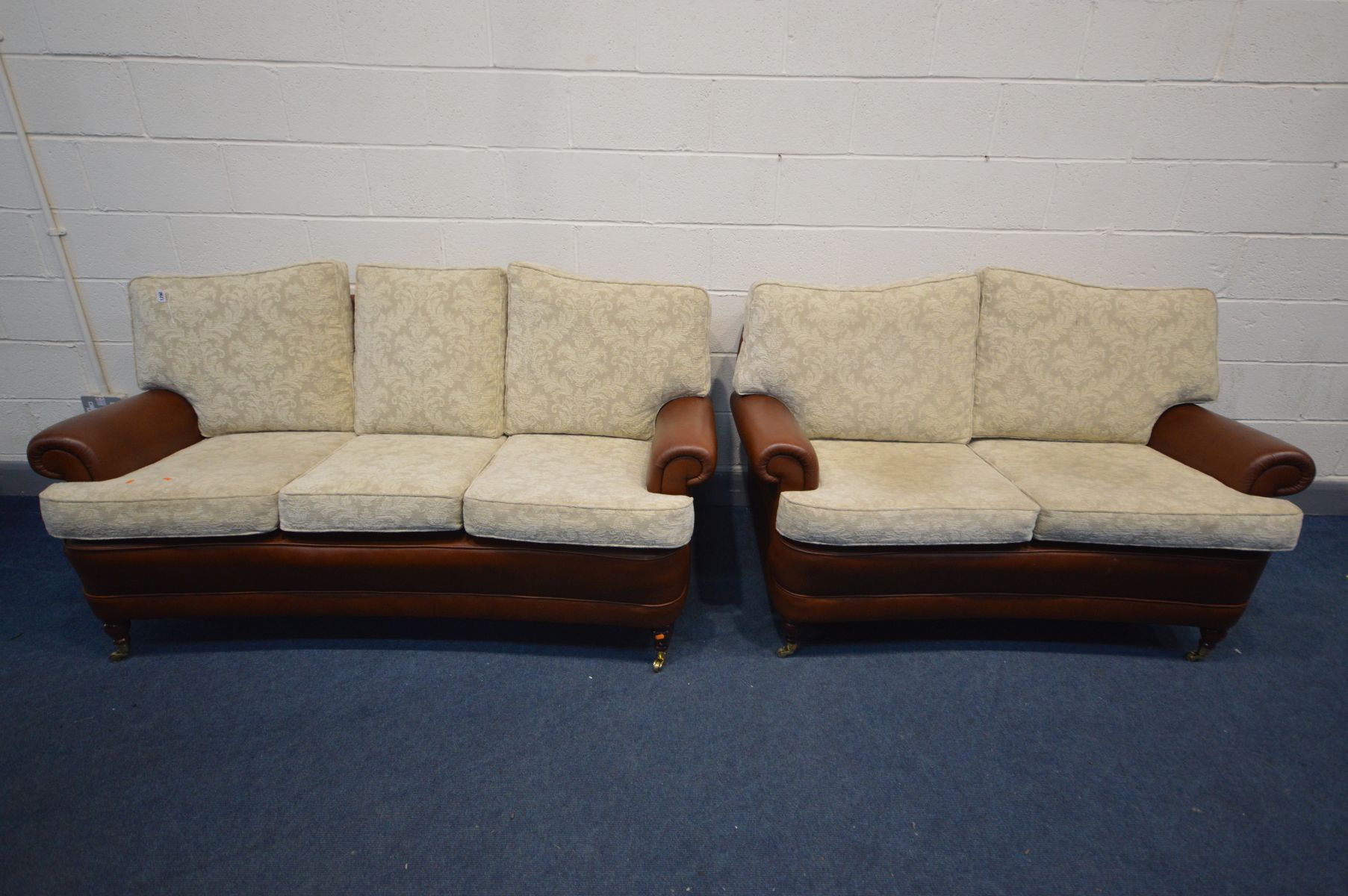 A BROWN LEATHER AND CREAM FABRIC TWO PIECE LOUNGE SUITE, comprising a three seater, length 183cm,