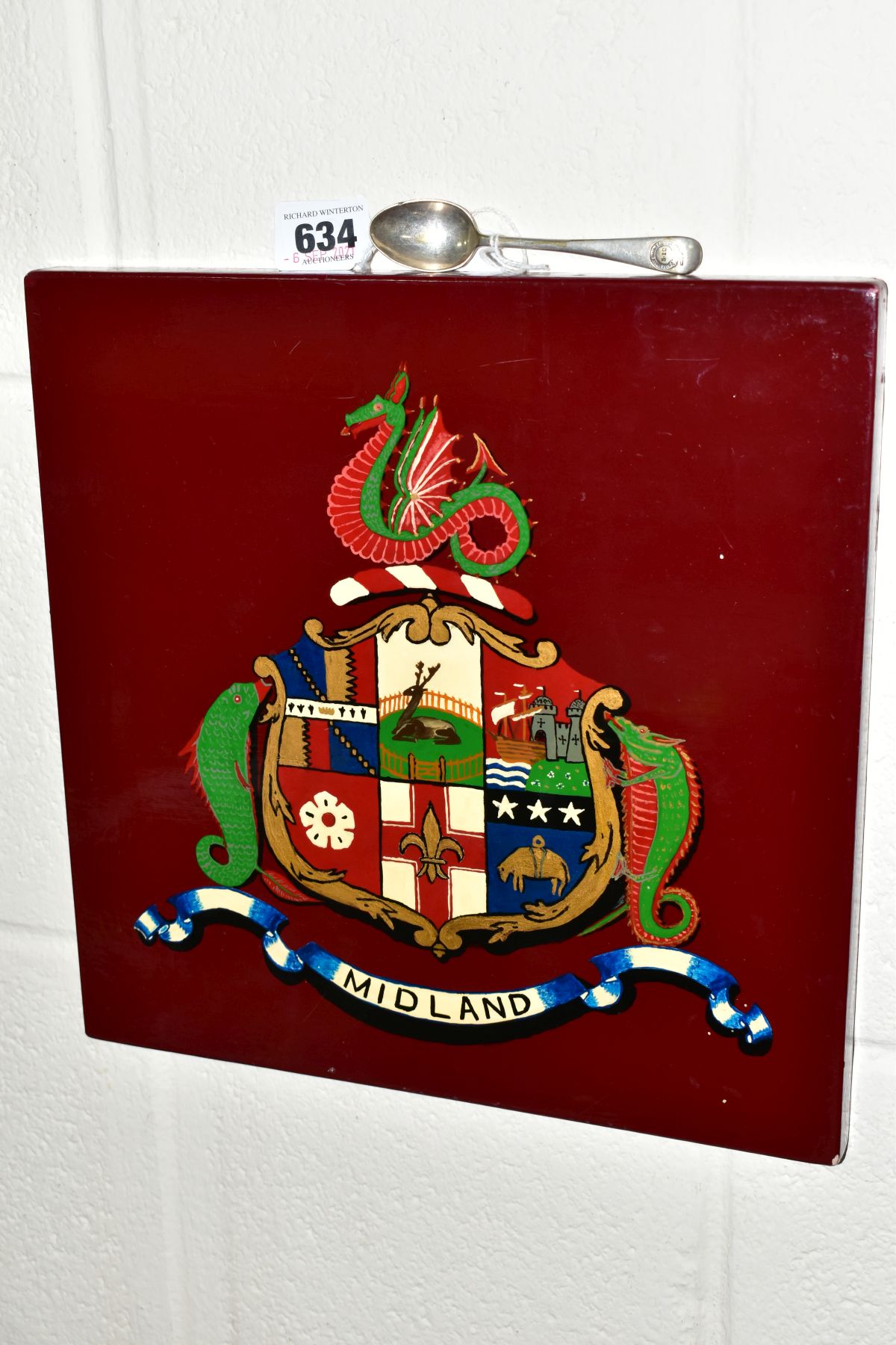 A WOODEN WALL PLAQUE THE CREST OF THE MIDLAND RAILWAY, size 30.5cm square, together with an EPNS