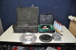 A CAMPING STOVE IN AN ABS CAMERA CASE with gas canisters, billy tin, folding cutlery sets, etc