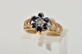 A 9CT GOLD SAPPHIRE AND DIAMOND CLUSTER RING, the raised cluster of a flower shape, set with a