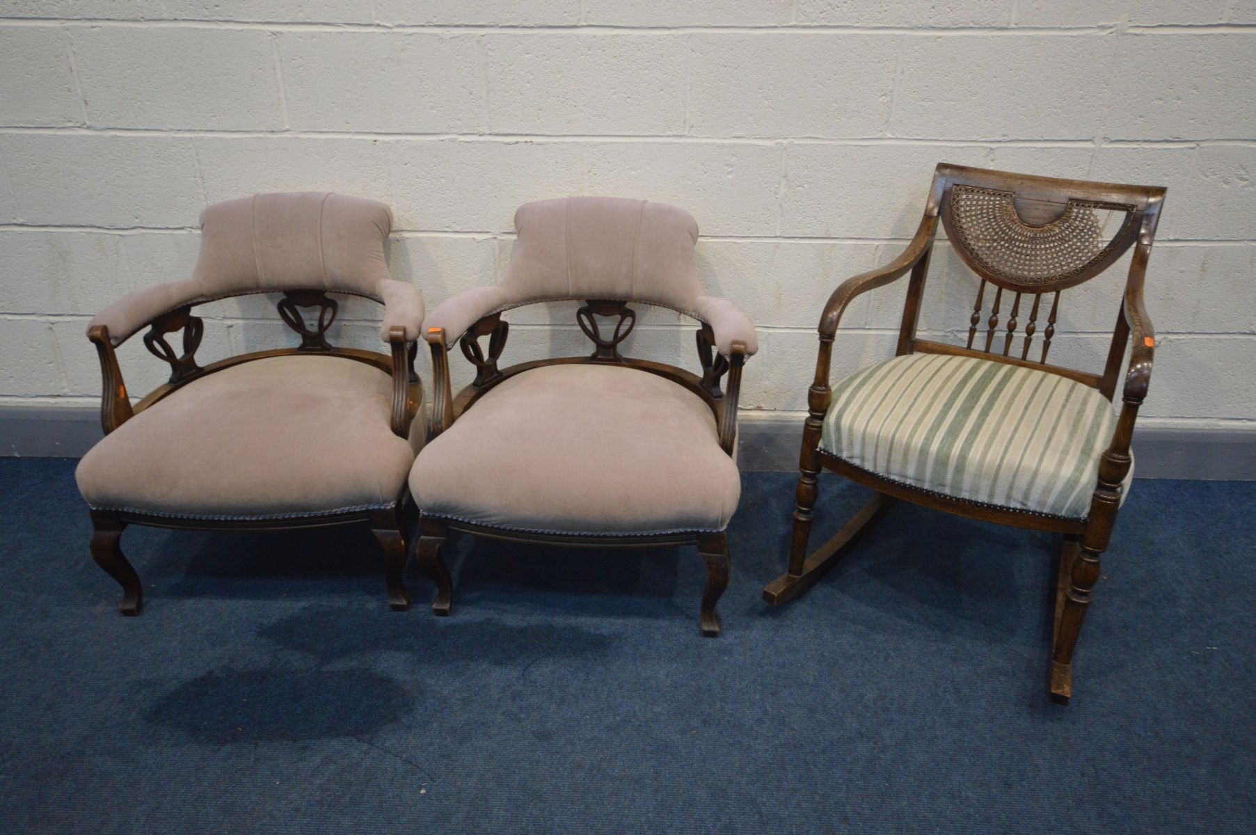 A PAIR OF EDWARDIAN MAHOGANY TUB CHAIRS, with Art Nouveau back, along with a beech bergère rocking