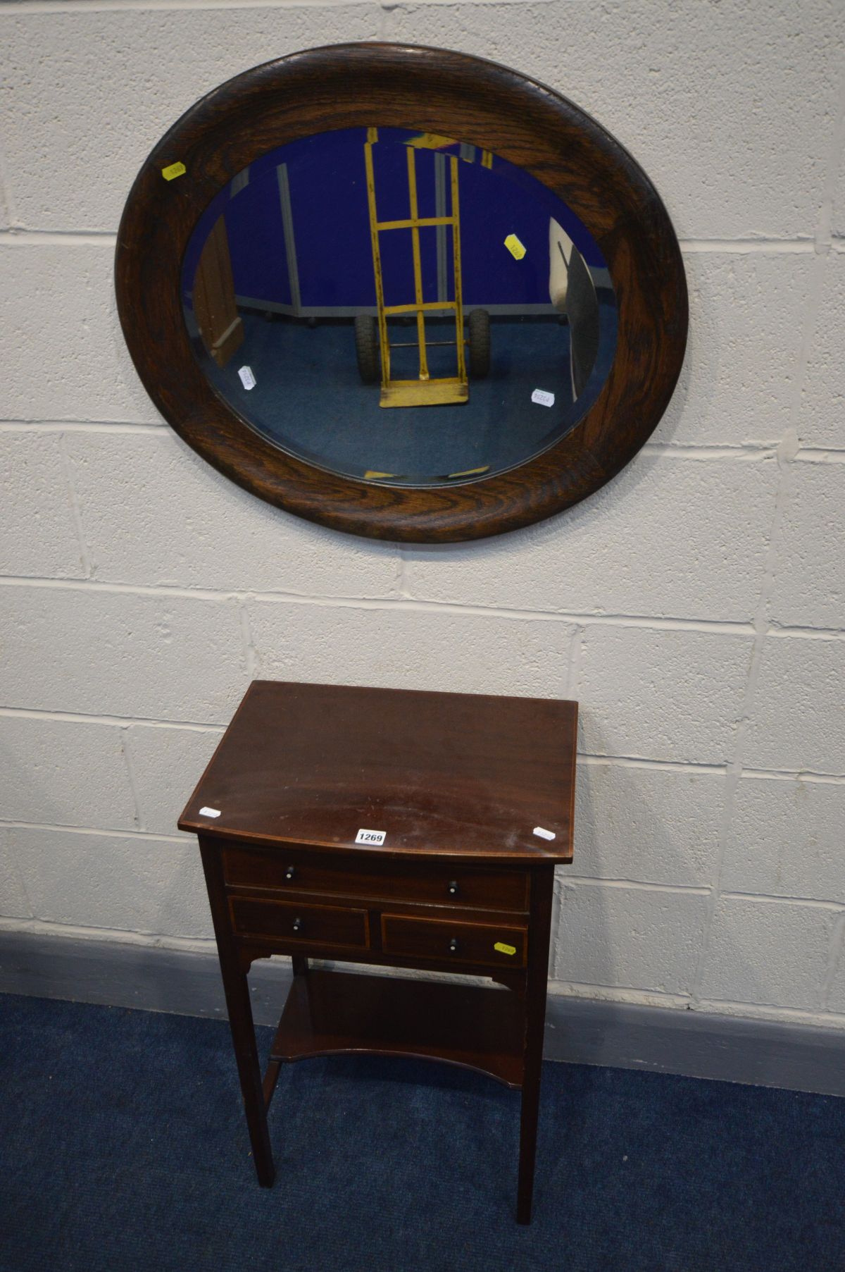 AN EDWARDIAN MAHOGANY WORK TABLE, the hinged top enclosing dividers, above two small exterior