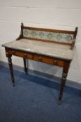 AN EDWARDIAN WALNUT WASHSTAND, marble top with a tile back and two frieze drawers, on turned legs