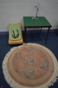 A WOOLLEN CHINESE PINK CIRCULAR RUG, diameter 127cm along with a folding bridge table, a bloom