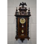 A LATE VICTORIAN WALNUT VIENNA WALL CLOCK, with a resin eagle pediment, height 102cm (winding key