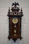 A LATE VICTORIAN WALNUT VIENNA WALL CLOCK, with a resin eagle pediment, height 102cm (winding key