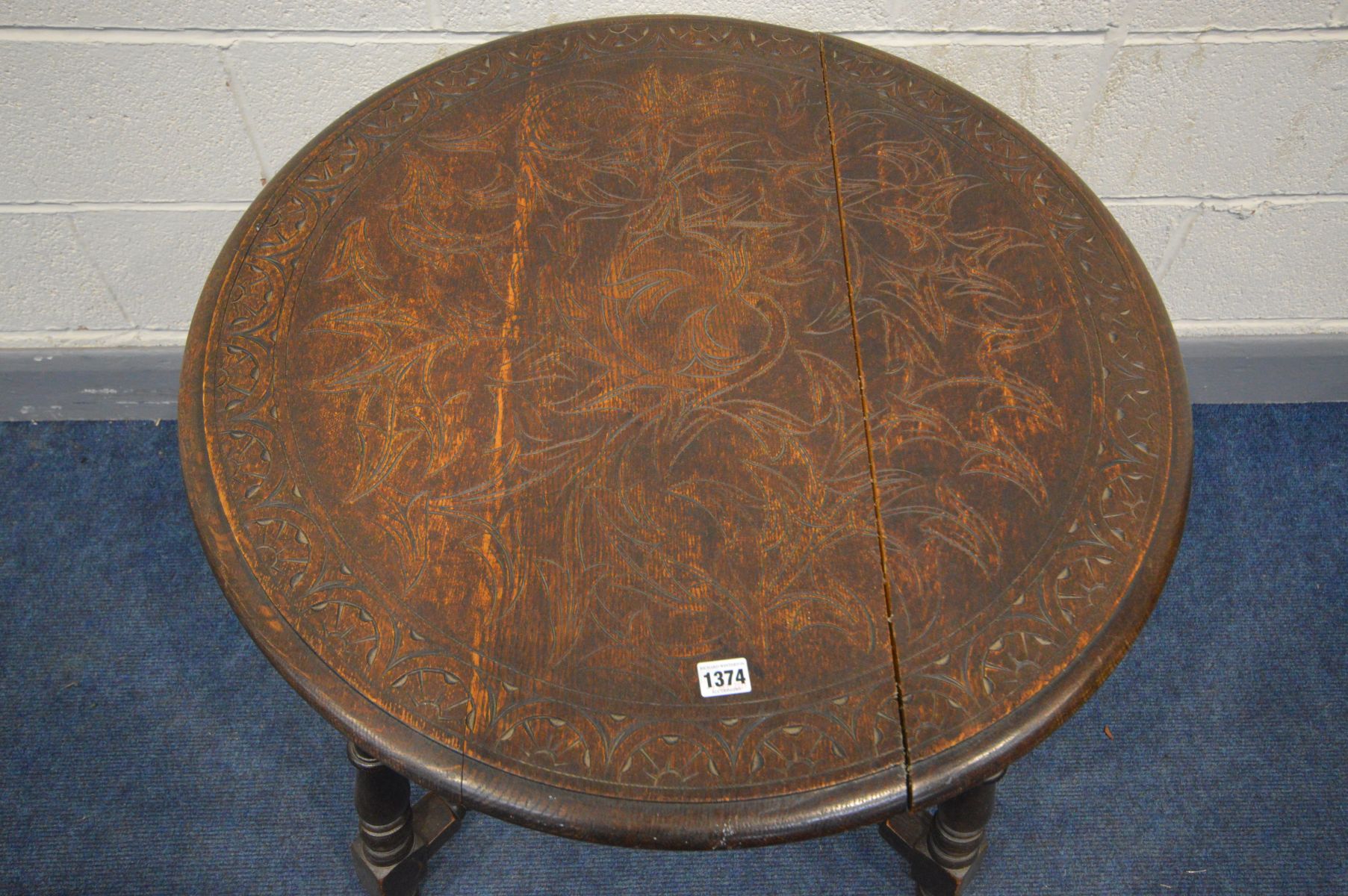 AN EARLY 20TH CENTURY CARVED OAK CIRCULAR CENTRE TABLE, on turned and block legs, united by - Image 2 of 3