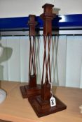 A PAIR OF 20TH CENTURY MAHOGANY AND STAINED CANDLESTICKS, square holder above four slender twisted