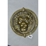 A CAST BRASS CIRCULAR DOOR KNOCKER, with Lion mask back plate and full circular frame knocker,