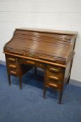 AN EARLY 20TH CENTURY OAK AMYL ROLL TOP DESK, the top with a fitted interior, on a pair of pedestals