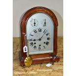 AN EARLY 20TH CENTURY MAHOGANY CASED DOME TOP MANTEL CLOCK, silver coloured arched dial with slow/
