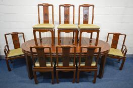 AN ORIENTAL HARDWOOD EXTENDING DINING TABLE, with rounded ends and two additional leaves, extended