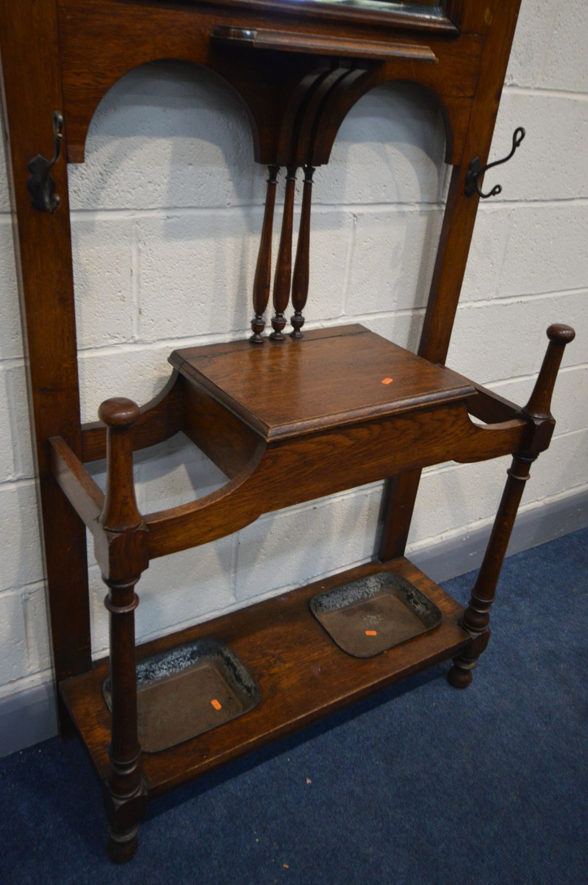 AN EDWARDIAN OAK HALL STAND, with six metal hooks, bevelled edge mirror, hinged storage - Image 3 of 3