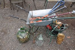 A MODERN WHEELBARROW, a quantity of garden tools, buckets and planters etc