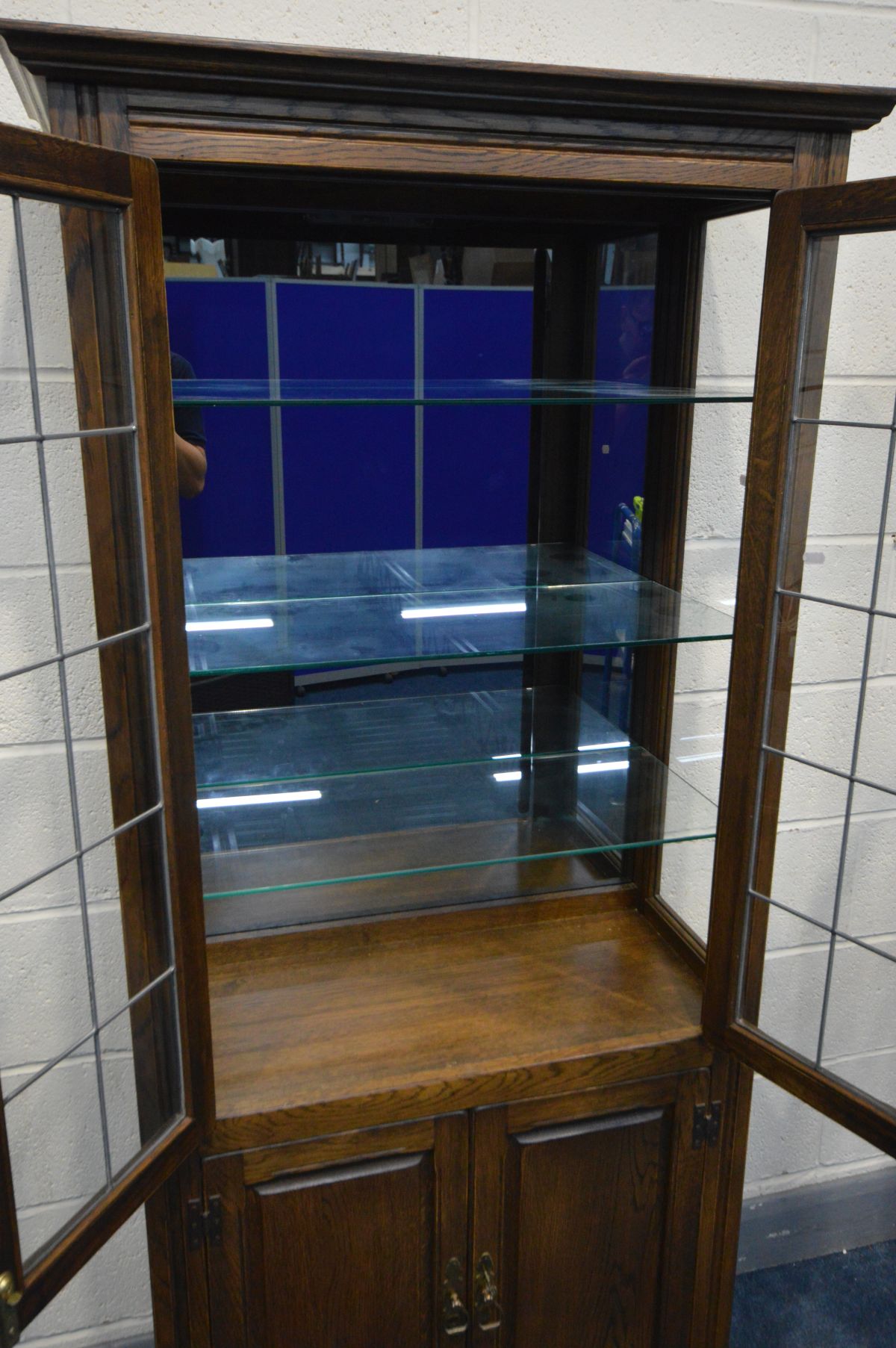 AN OAK LEAD GLAZED TWO DOOR DISPLAY CABINET, enclosing three glass shelves and smoked mirror back, - Image 3 of 3