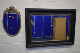AN OKA BLACK AND GILT WALL MIRROR, 114cm x 84cm and a gilt framed wall mirror (2)