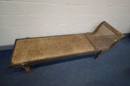 A 19TH CENTURY ANGLO-INDIAN CANED HARDWOOD DAYBED, with a scrolled and swept top rail, on bulbous