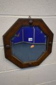 A MID 20TH CENTURY OAK BEVELLED EDGE OCTAGONAL WALL MIRROR, diameter 42cm