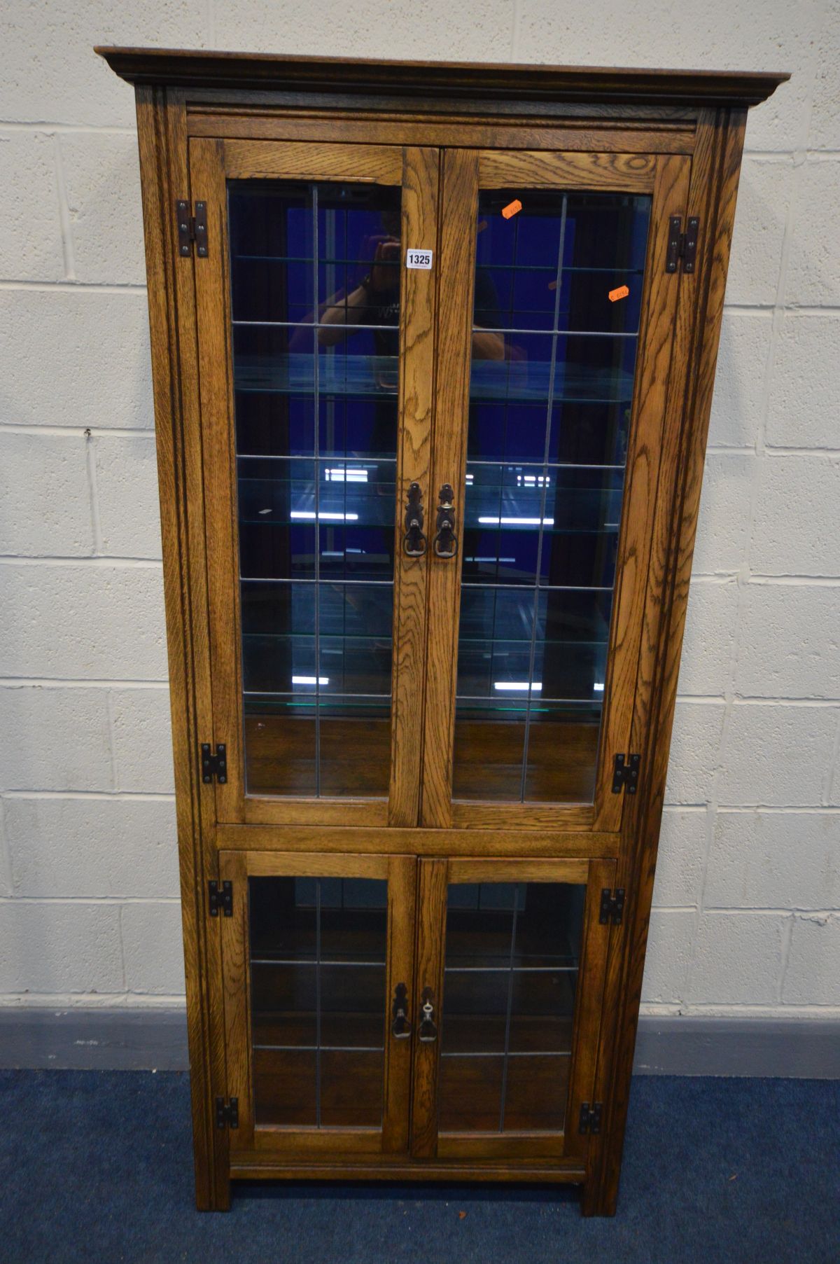 AN OAK LEAD GLAZED FOUR DOOR DISPLAY CABINET, enclosing five glass shelves and smoked mirror back, - Image 2 of 3