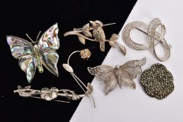 SEVEN WHITE METAL BROOCHES, to include a marcasite flower stamped 'Sterling silver', an abalone