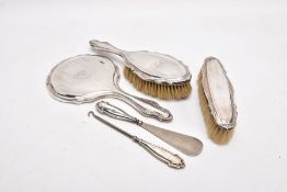 A THREE-PIECE SILVER VANITY SET A BUTTON HOOK AND A SHOEHORN, the vanity set comprising of a