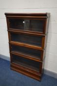 AN EDWARDIAN MAHOGANY FOUR SECTIONAL BOOKCASE, with glazed fall front doors, width 87cm x depth 27cm