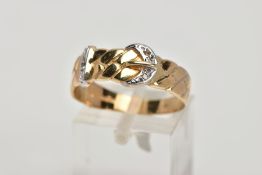 A 9CT GOLD DIAMOND BELT BUCKLE RING, textured belt design, set with single cut diamond detail (one