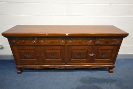 AN ORIENTAL HARDWOOD SIDEBOARD, four short drawers above four cupboard doors, width 203cm x depth