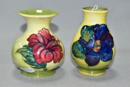 TWO SMALL MOORCROFT POTTERY VASES, comprising a baluster shaped vase in Clematis pattern with purple