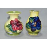 TWO SMALL MOORCROFT POTTERY VASES, comprising a baluster shaped vase in Clematis pattern with purple