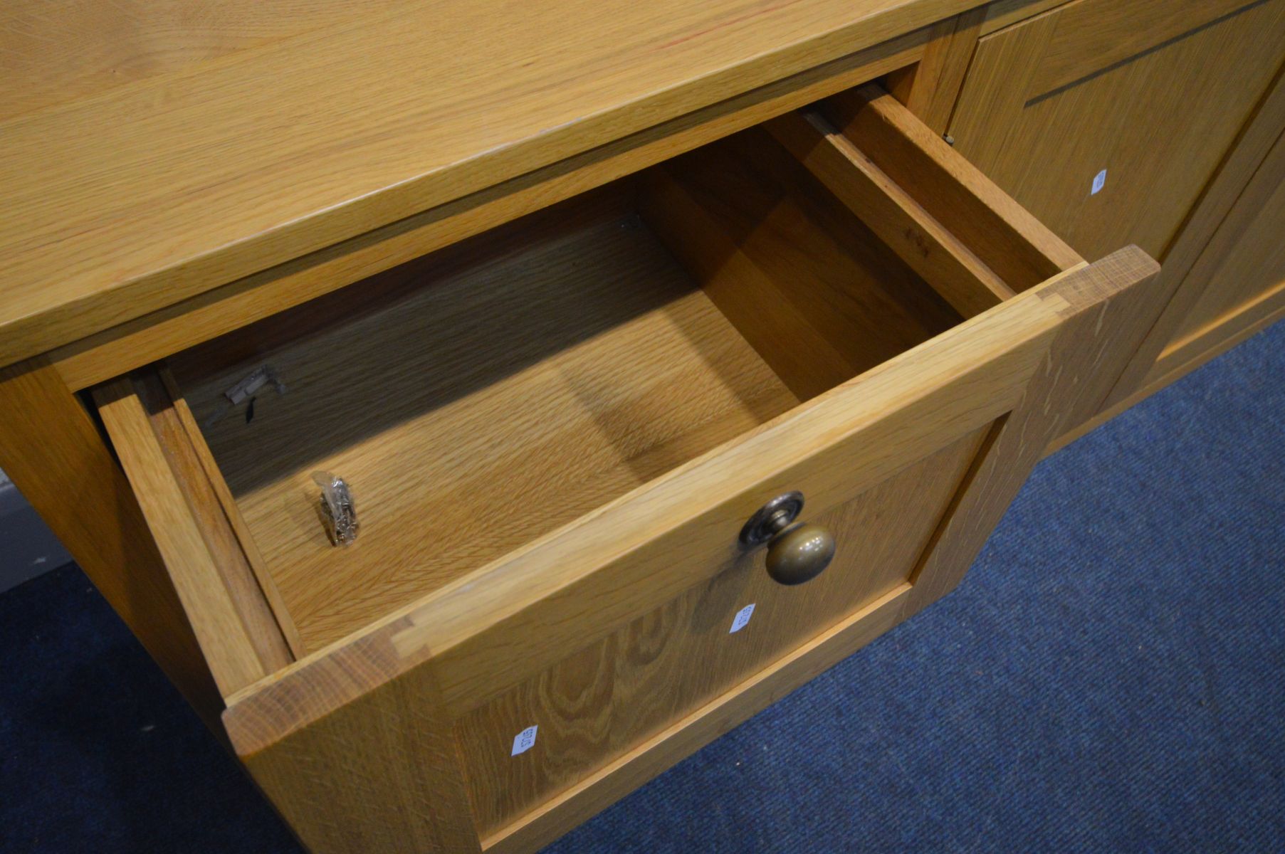 A LIGHT OAK SIDEBOARD with four deep drawers flanking double cupboard doors, width 204cm x depth - Image 2 of 3