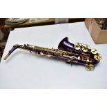 A CASED JOLLYSUN BY INTERNATIONAL ENGINEERING SAXOPHONE, in brass and metallic purple finish,