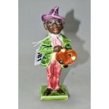 A LATE 19TH CENTURY CONTINENTAL POTTERY FIGURE OF AN ARTIST HOLDING HIS PALETTE, with majolica style