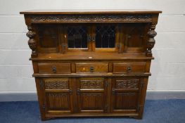 AN OLD CHARM OAK COURT CUPBOARD, with double lead glazed doors above three drawers and three