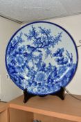 A LATE 19TH CENTURY JAPANESE PORCELAIN CHARGER, blue and white decoration of an exotic bird