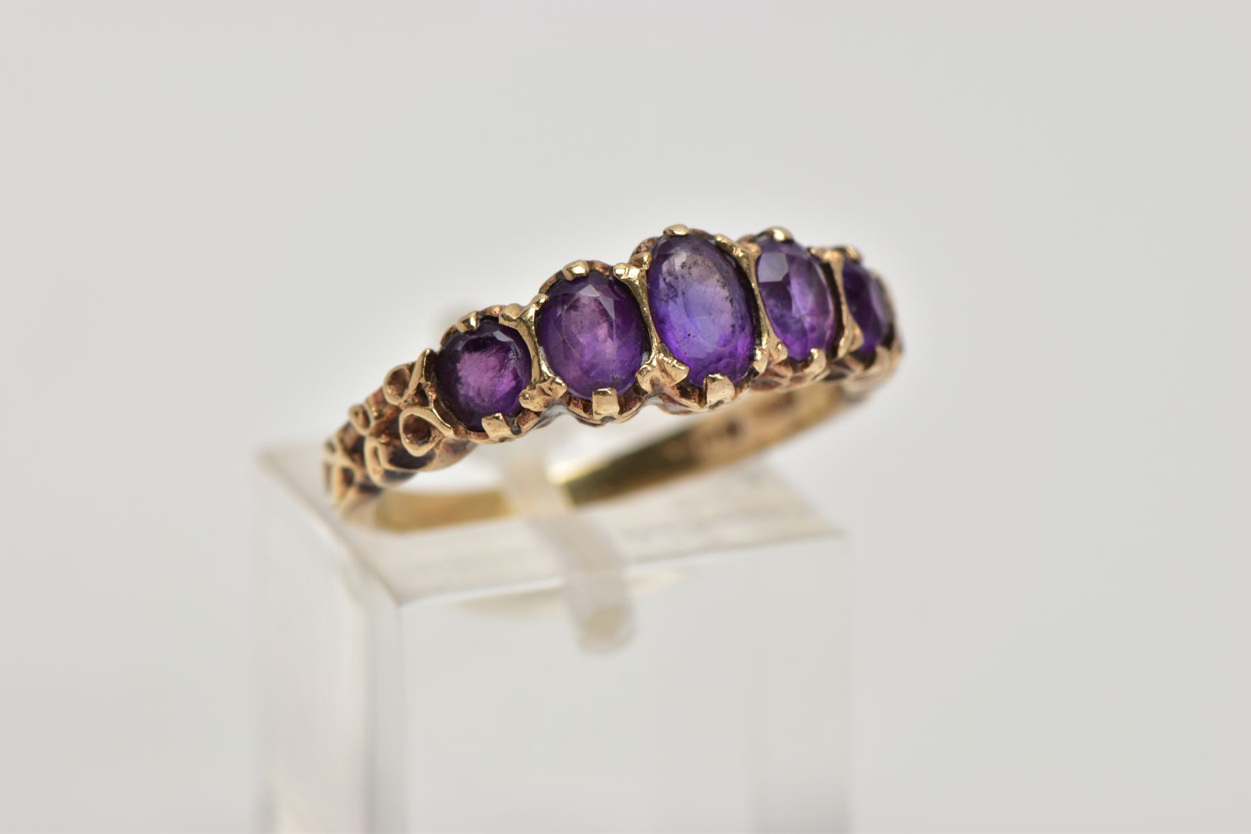 A 9CT GOLD FIVE STONE AMETYHST RING, designed with a row of five graduated oval cut amethyst, scroll - Image 4 of 4