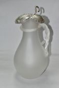 A FROSTED GLASS WATER JUG OF BALUSTER FORM, with vine leaf shaped white metal hinged cover,