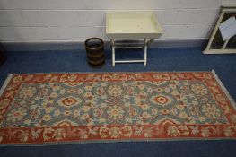 A WOOLLEN RED AND BLUE CARPET RUNNER, 280cm x 93cm, along with a cream folding butlers tray and an