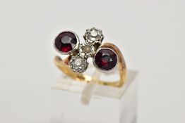 AN EARLY 20TH CENTURY 18CT GOLD GARNET AND DIAMOND DRESS RING, of a cross over design, the centre