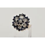 A 9CT GOLD SAPPHIRE AND DIAMOND CLUSTER RING, the tiered cluster claw set with circular blue
