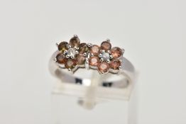 A 9CT WHITE GOLD CLUSTER RING, designed with two flower shaped clusters, each set with a central