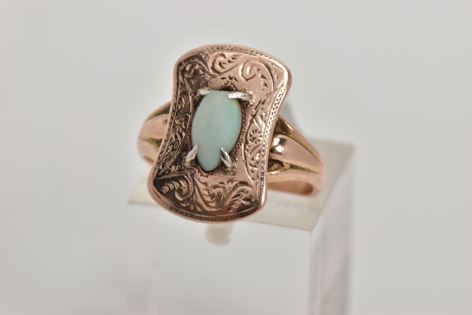 AN EARLY 20TH CENTURY 9CT GOLD OPAL RING, the head of the ring of a rounded rectangular shape with
