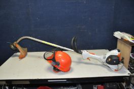 A STIHL FS40 PETROL STRIMMER and a Stihl Helmet with ear defenders and screen attached (starts and
