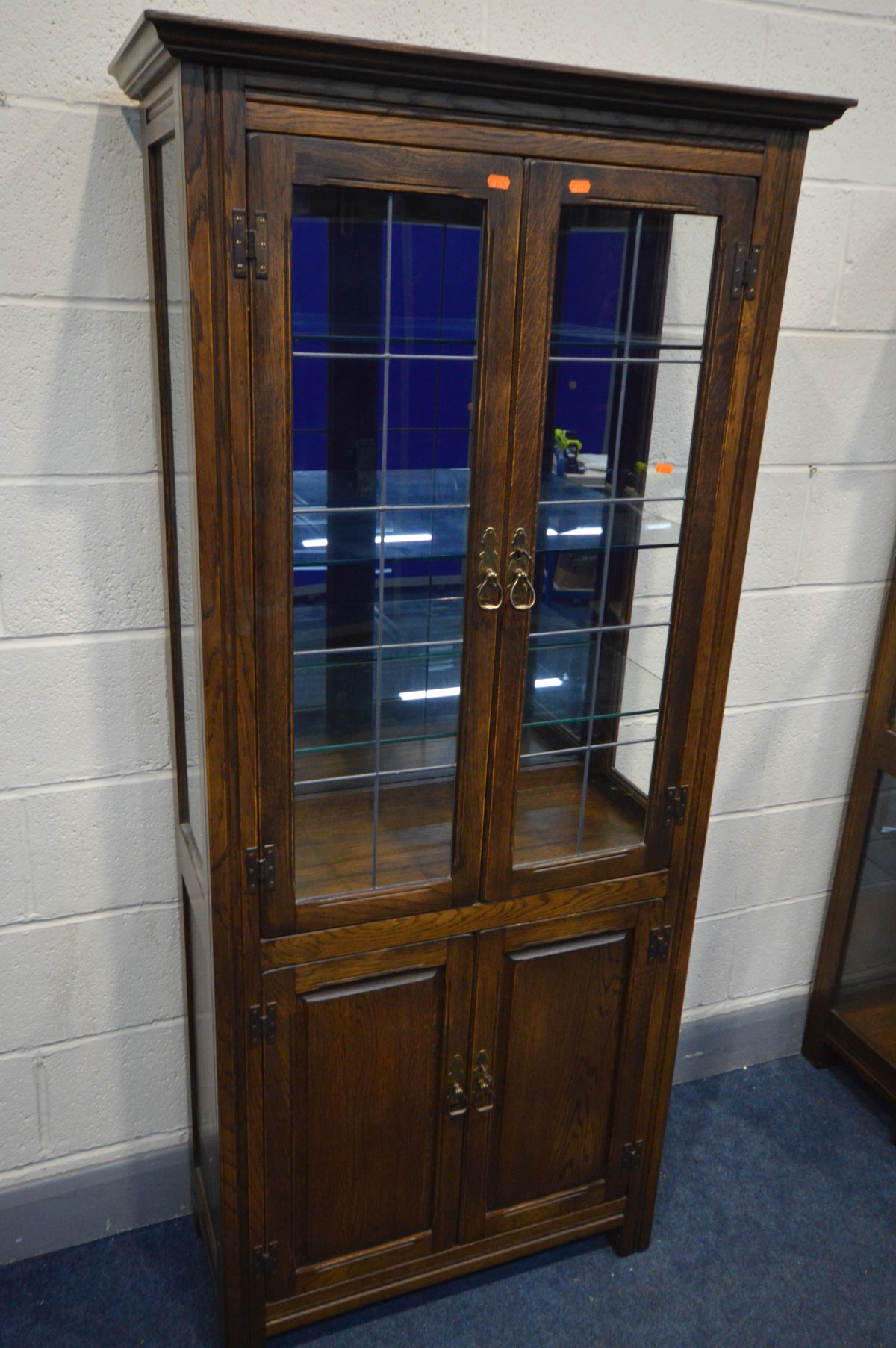 AN OAK LEAD GLAZED TWO DOOR DISPLAY CABINET, enclosing three glass shelves and smoked mirror back, - Image 2 of 3