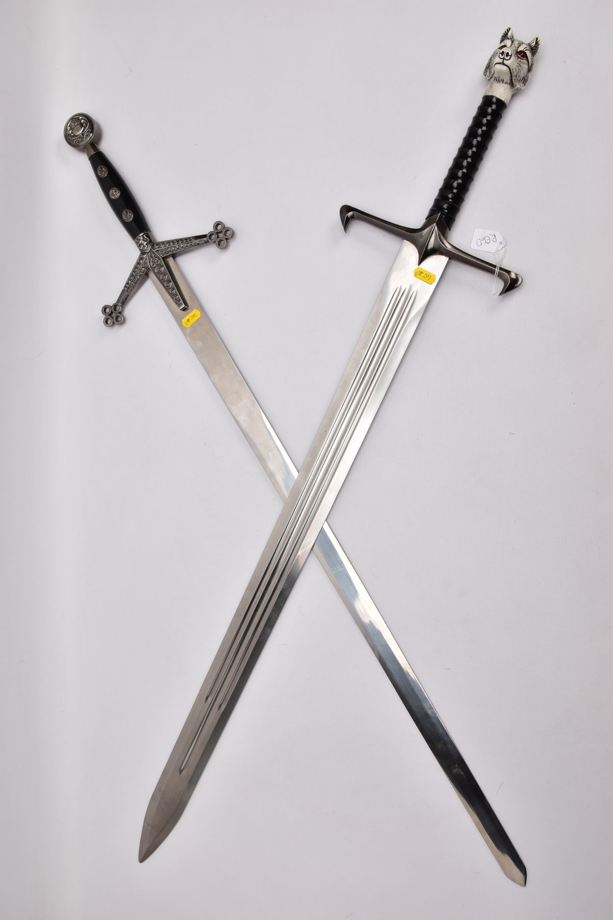 TWO REPLICA COPY SWORDS a Medieval style approximately 83cm length blade, angled downward cross-