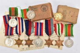 A BOXED GROUP OF FOUR WWII MEDALS to include 1939-45, Italy Stars, Defence & War medal with award