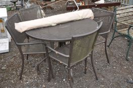 A MODERN METAL GARDEN TABLE 107cm in diameter, four similar chairs and a parasol